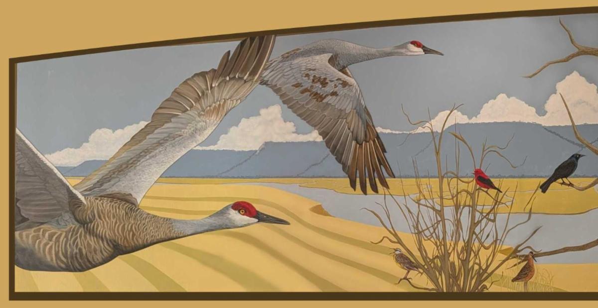Section of a painted mural by Susan Mundy showing birds flying on a yellow and blue background.