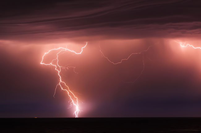 Intense lightning striking the ground during a storm