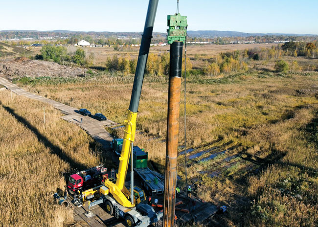 Billboard installation using a vibratory hammer