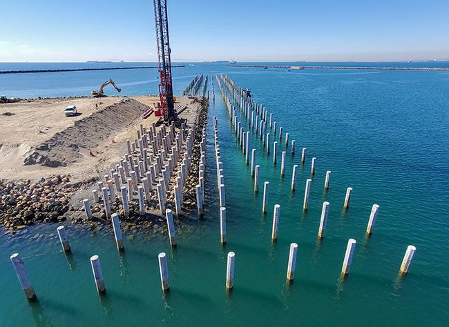Manson crew driving land production piles with a Manitowoc 2250 on the east side of the P226 Ammunition Pier project at Naval Weapons Station Seal Beach in California