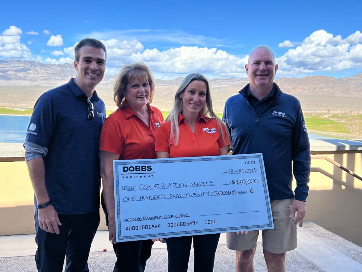 Showcasing a large check as an industry donation to Construction Angels