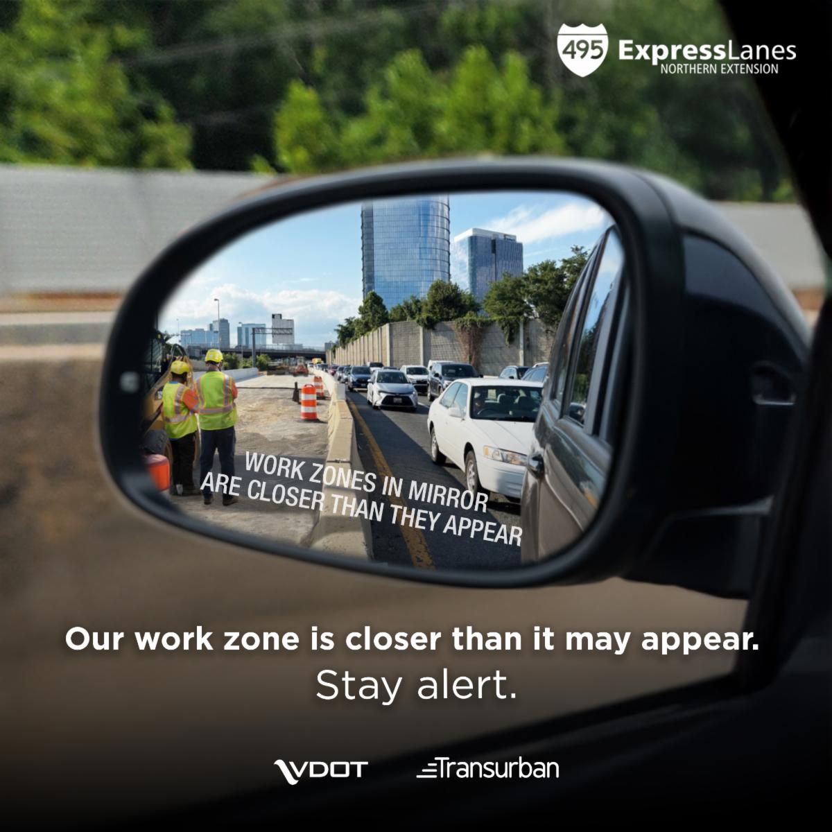495 Express Lanes Northern Extension image showing a car's side-view mirror with construction workers in nearby work zone. Text in side-view mirror reads "WORK ZONES IN MIRROR ARE CLOSER THAN THEY APPEAR." Text at the bottom of the image reads "Our work zone is closer than it may appear. Stay alert." The VDOT and Transurban logos appear below the text at the bottom of the image.