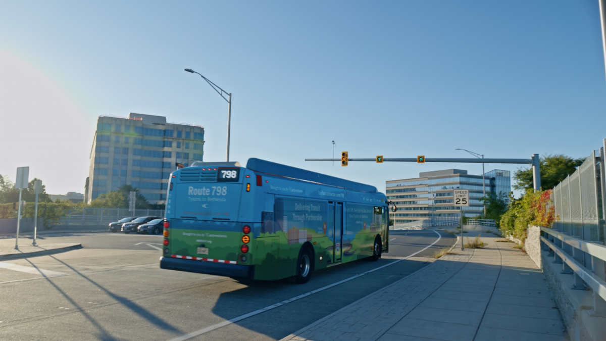 Fairfax Connector Route 798 bus driving along road in Tysons, Virginia.