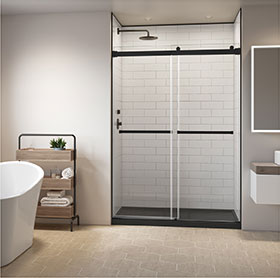 Gemini Plus in-line door in matte black, with white tiled Fibo by Fleurco wall in shower enclosure, black base