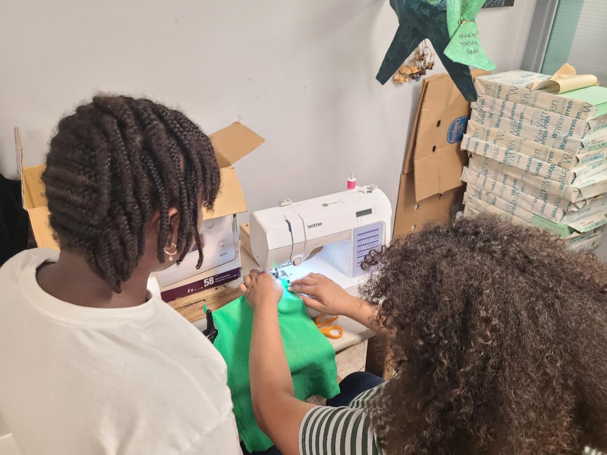 Kids learning to use a sewing machine