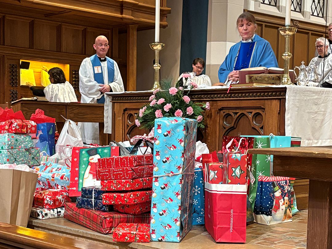 Christmas gifts are laid in front of the altar