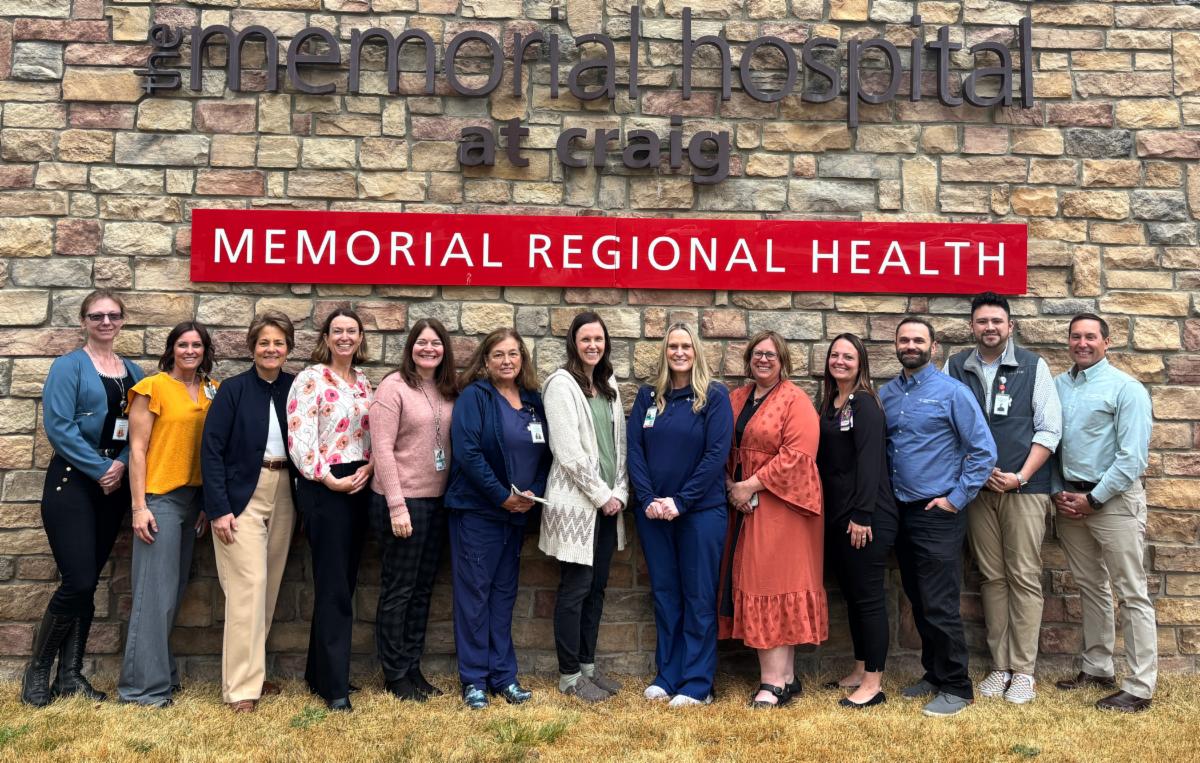 MRH's Copper Team standing in front of the hospital sign