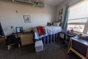 Inside a room in Blue Hall with open floor space and furnishings arranged throughout the room.