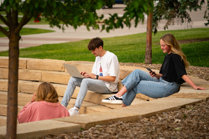 Group of students enjoying the weather but still studying