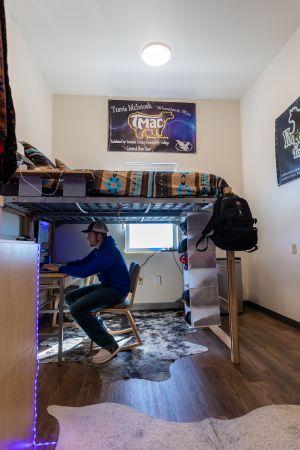 Student studying in his room in Gold Hall