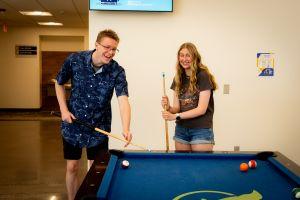 Students playing pool in Gold Residence Hall
