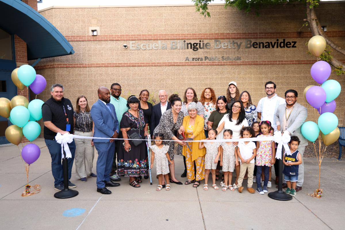APS Board members, Superintendent Michael Giles, Jr., Principal Anabel Rafoul and Aurora Mayor Mike Coffman assist Betty Benavidez's daughter Susan Castro cut the ribbon at the Escuela Bilingüe Betty Benavidez Grand Opening.