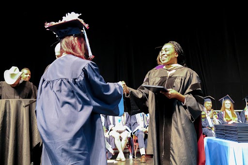 dr keke handing out a diploma
