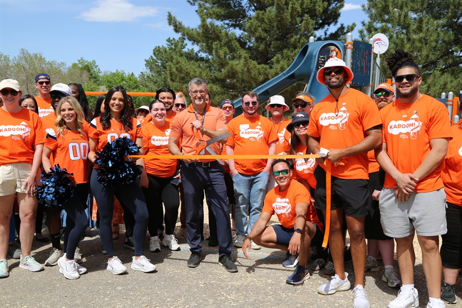 Iowa Principal Jason Smith cuts the ribbon for the new playground
