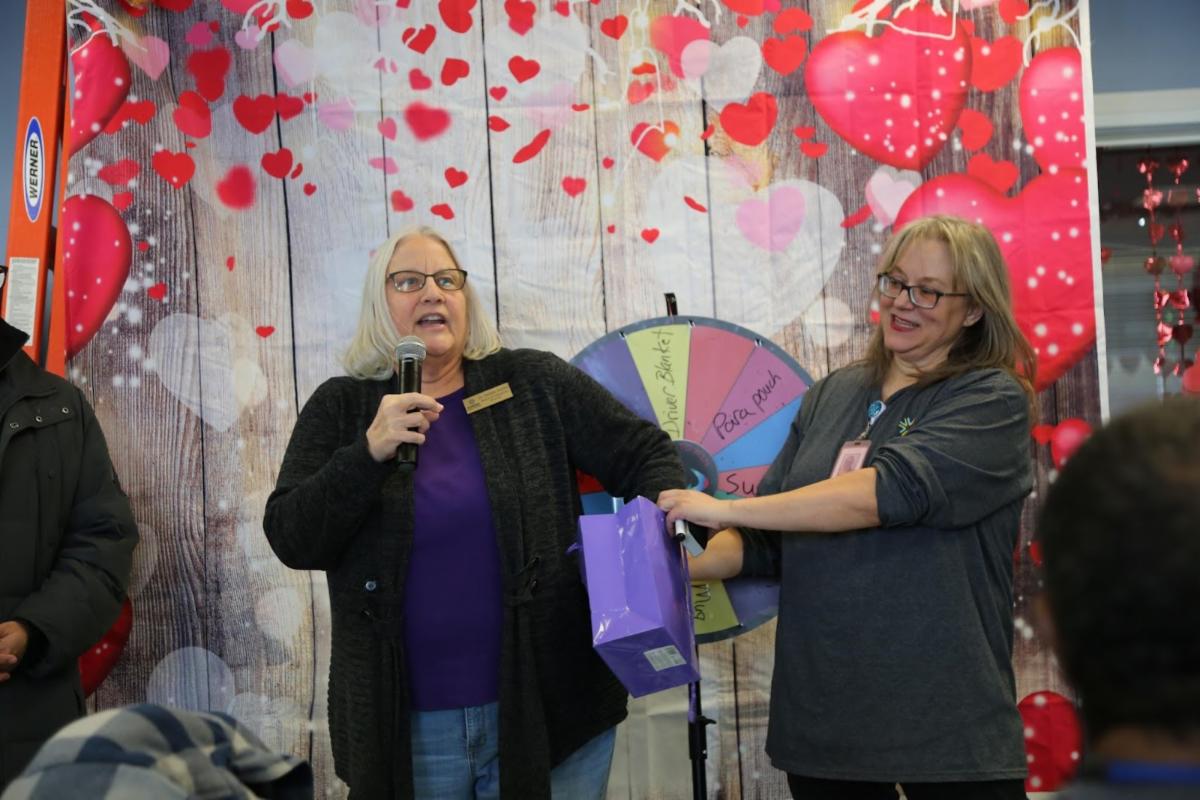 Debbie Gerkin spins the awards wheel at Love the Bus Day