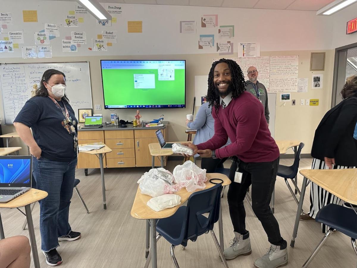 Mrachek staff receive breakfast burritos from the Board