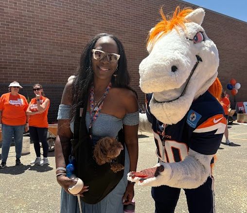 board secretary Gayla Charrier with Denver Broncos mascot Miles at the Iowa Ribbon Cutting Ceremony for the new playground