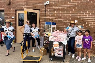 students and staff members outside of the school prepping for the Clyde Miller carnival