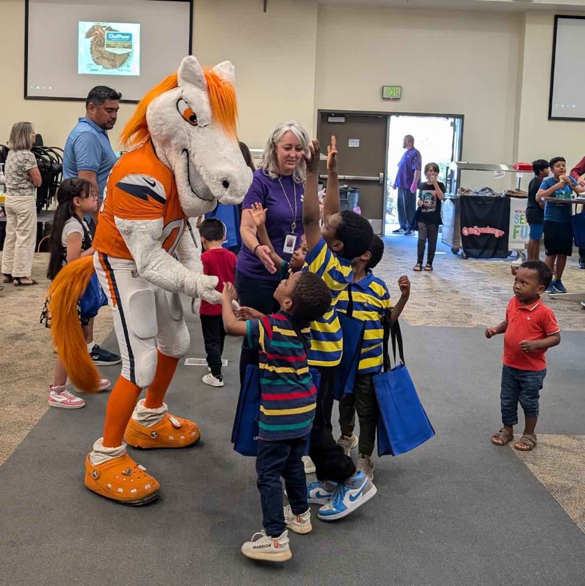 Denver Broncos mascot Miles welcomes students at the Aurora Meet and Eat