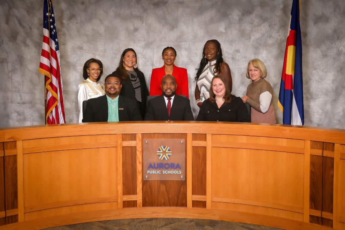 the Aurora Public Schools Board of Education posing with Superintendent Michael Giles, Jr.