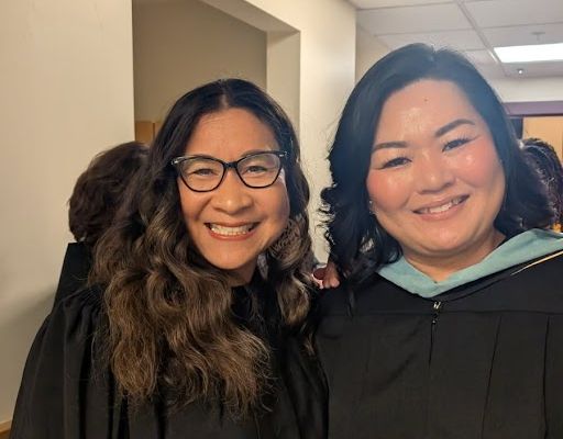 Board Vice President Danielle Tomwing and APS Avenues Principal Ran Jung prepare for graduation ceremony