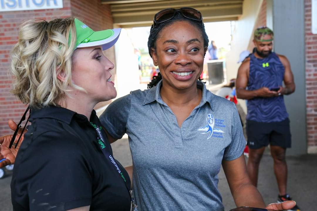 Board President Dr. Anne Keke with a representative from Kelly Education Services at the APS Stadium Grand Reopening
