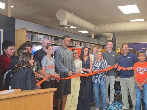 Denver Bronco Patrick Surtain II cuts the ribbon at the grand opening of the STEAM Inspiration Room at Columbia Middle School.