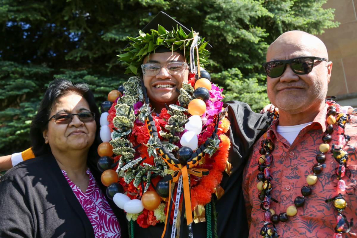 APS student graduate surrounded by their family