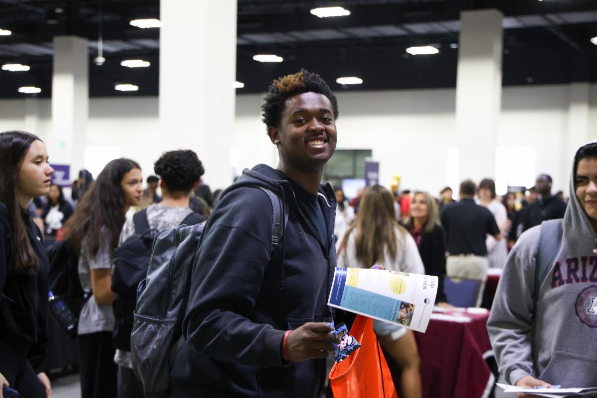 Smiling APS student attends a college fair
