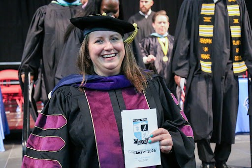 Board Directory Kristin Mallory prepares to participate in the Vista PEAK Preparatory graduation ceremony.