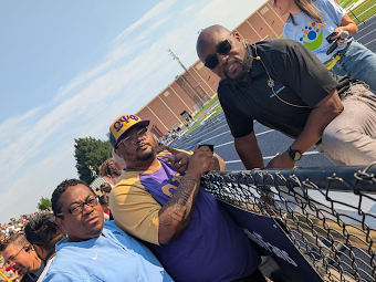 two aps board members with superintendent at all staff kickoff