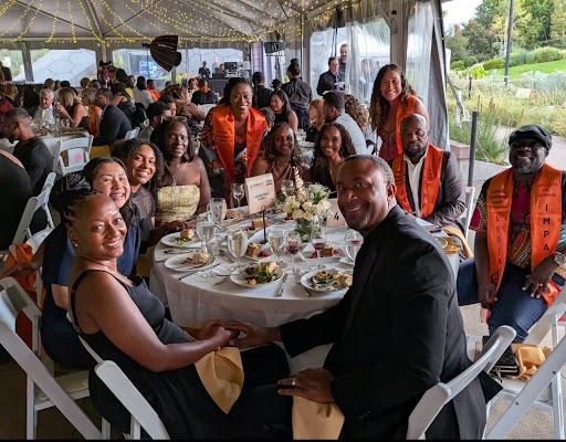 Superintendent Michael Giles, Jr. (top right) with others at the AfrikImact event to receive his award.