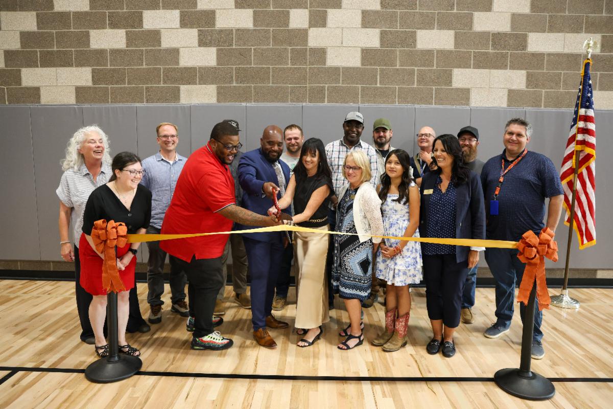 Superintendent Mike, Principal Megan Ortiz-Capozzolo, Board members and others at the ribbon cutting for the Coal Creek P-8 grand opening.