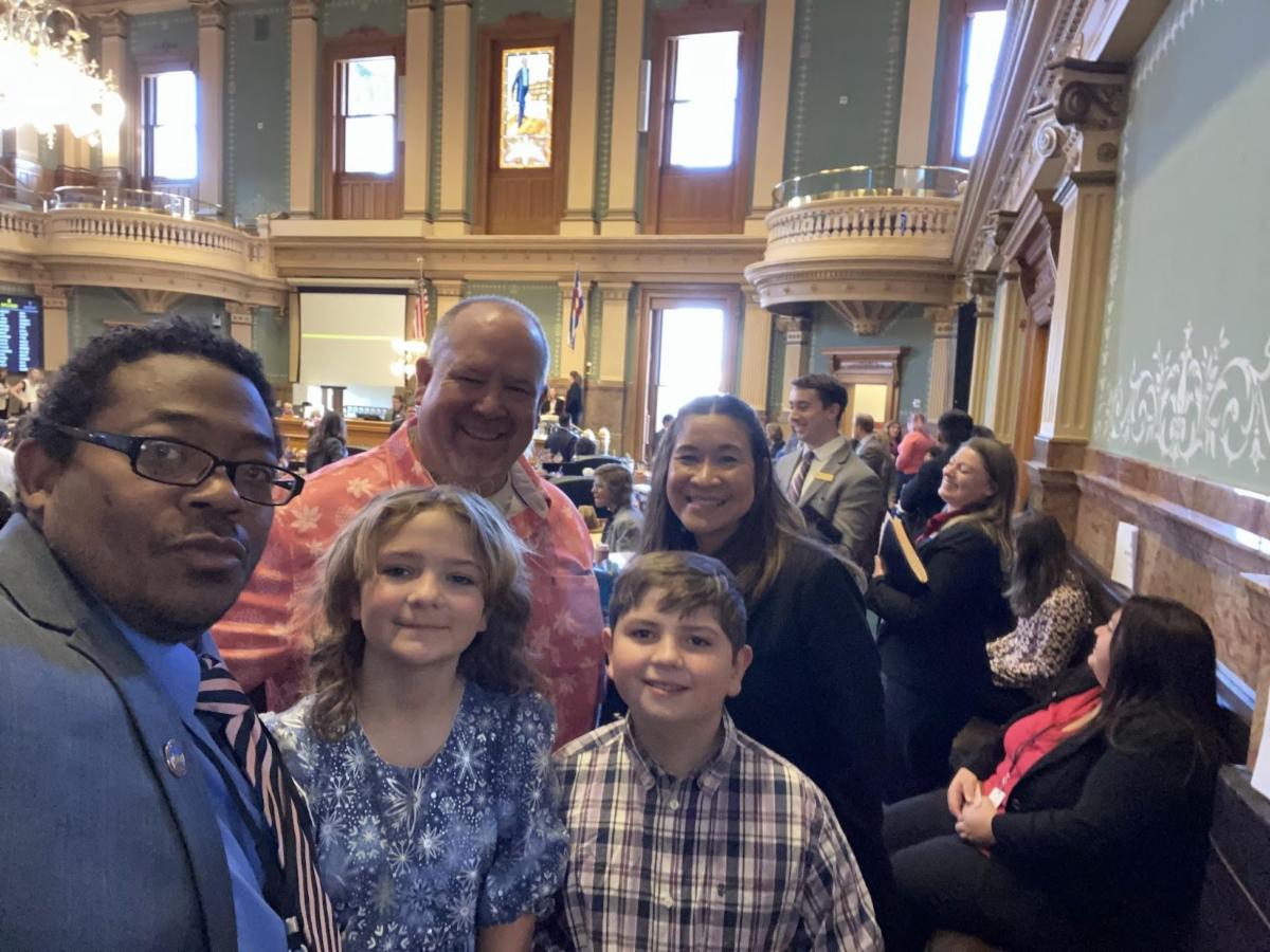 Board Vice President Michael Carter and Board Secretary Danielle Tomwing with APS students and parents