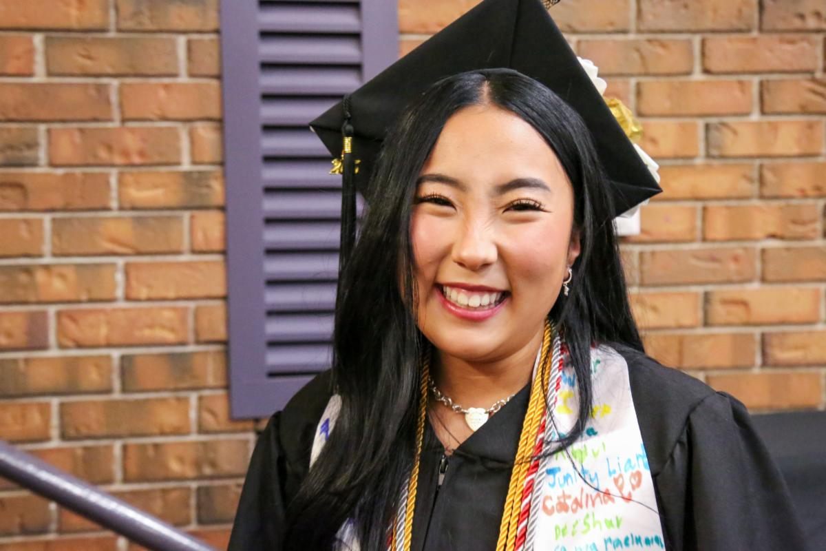 smiling aurora public schools graduate