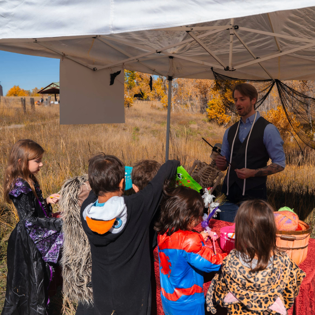 Children and adults enjoying activities at last year's Trick or Treat Nature Trail links to page with more information