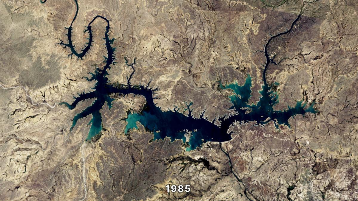 A natural-color Landsat image of the Amistad River. In the image, bare earth appears tan, the deep parts of the reservoir appear dark blue and the shallow areas around the reservoir appear light blue. The reservoir resembles a dragon.
