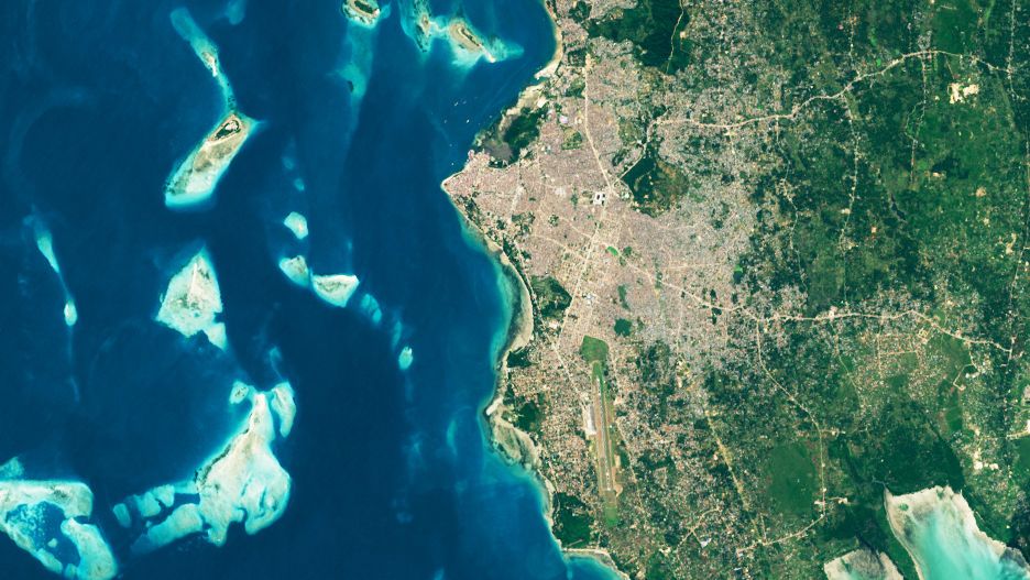 The image of Stone Town shows the city in 2024. In this image, the urban area is considerably larger, having expanded inland in all directions.