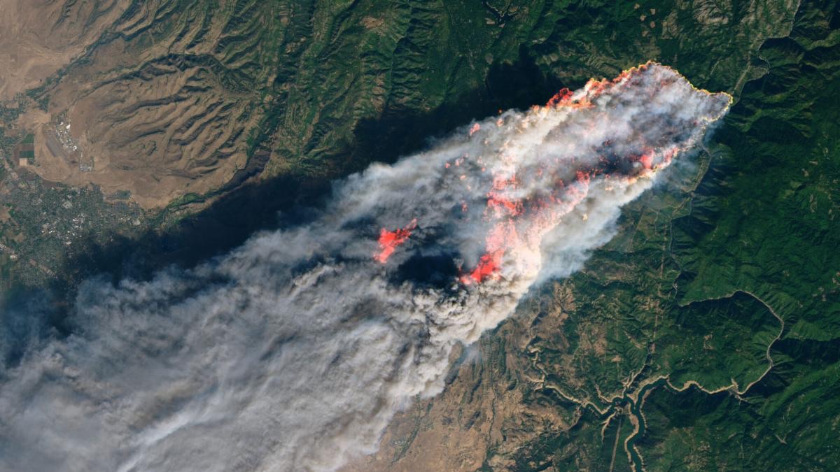 Landsat image of the Camp Fire in California acquired in 2018. The natural-color image is overlaid with a shortwave infrared signature.
