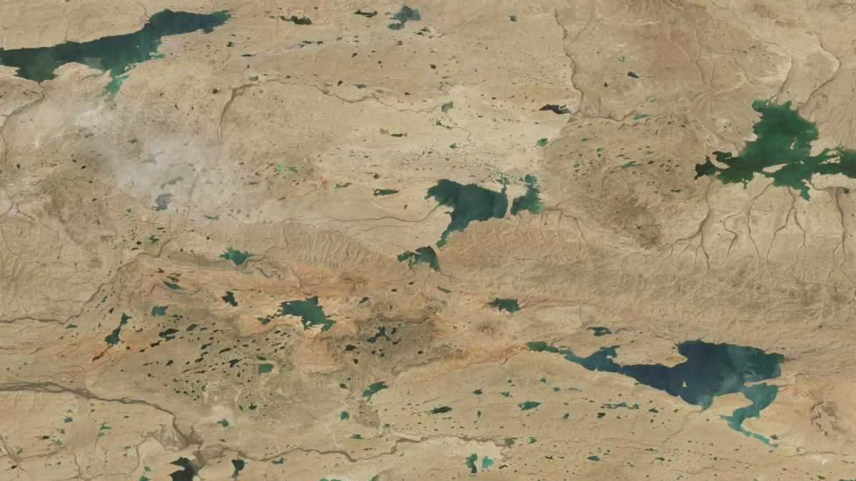 A second image taken in 2024 shows the same area. The landscape is the same color except now there are dozens of new lakes visible. Lakes that were visible in the 1994 image are much larger.