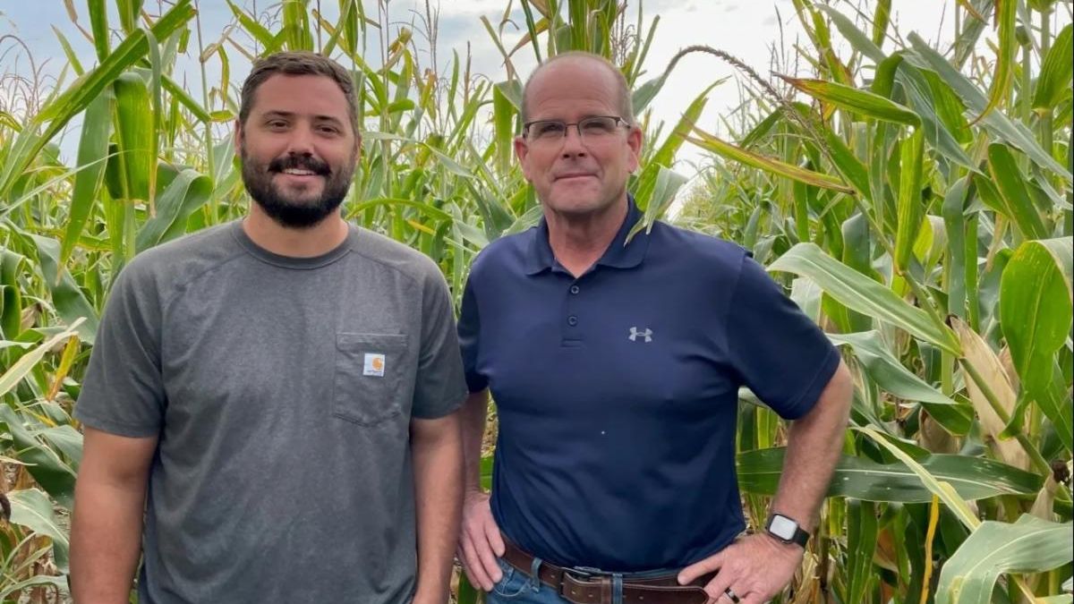 Dwane Roth (right), a fourth generation grain farmer in Finney County, Kansas, stands with nephew Zion (left) in one of their corn fields. Roth’s farm became one of the first Water Technology Farms in Kansas around 2016, and he has been using OpenET data for the past few years to track evapotranspiration rates and conserve water. Photo courtesy of Dwane Roth