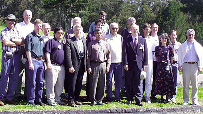 The Landsat 7 Science Team stands against a forested background at the launch of the Landsat 7 satellite, April 15, 1999. 