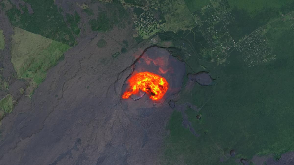 The heat signature from an eruption at Kilauea glows yellow and orange in the volcano’s summit crater.