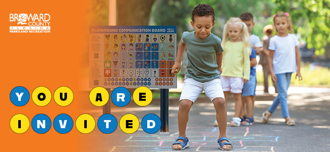 Children playing hopscotch near a communication board