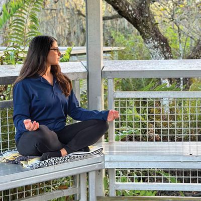 Naturalist sitting on a mat in the park. 