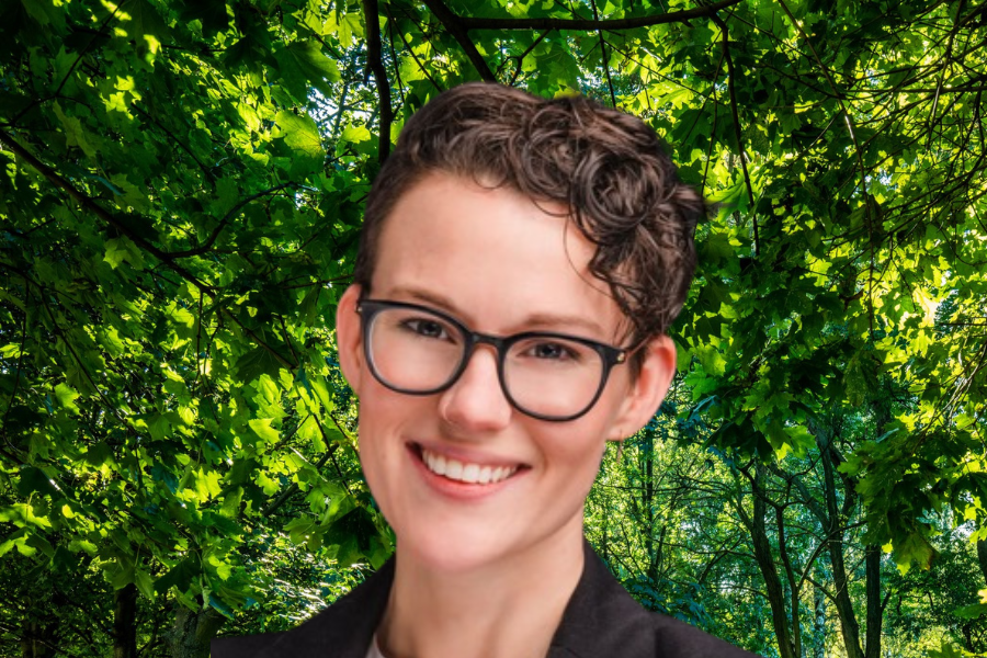 Jean Jarrett - woman with short curly dark hair and glasses smiling