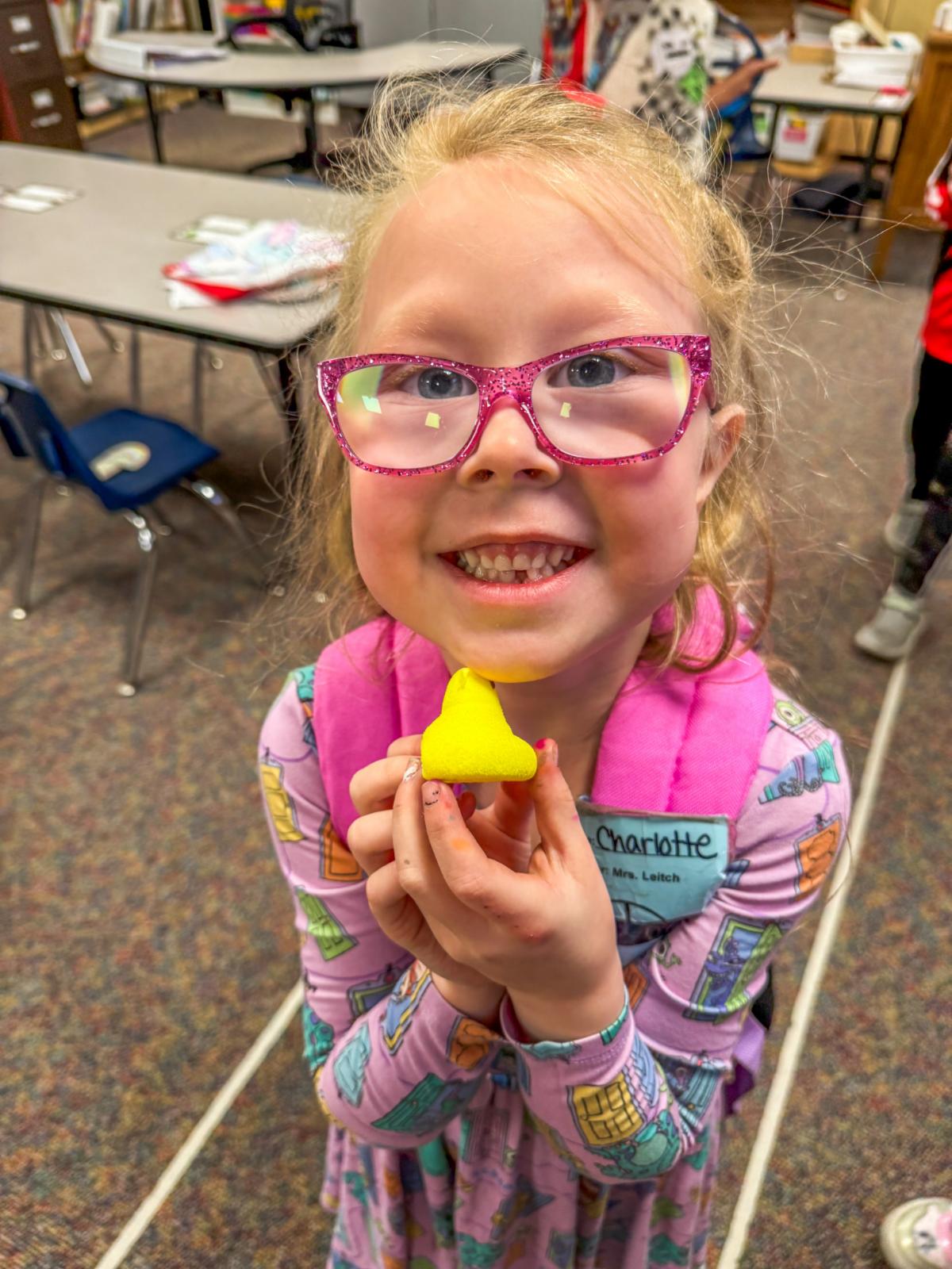 Student holding her Peep marshmallow treat. 