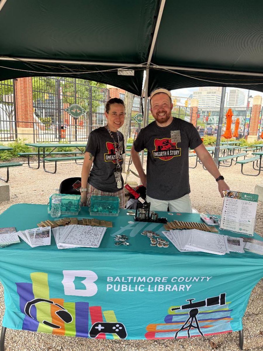 Baltimore County Public Library staff stand behind their table at Orioles' Literacy Night.