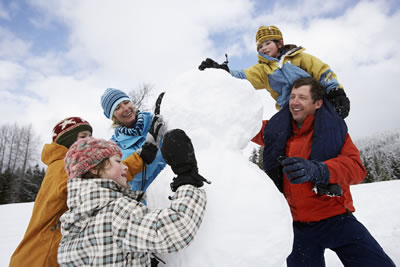 Family building a snowman