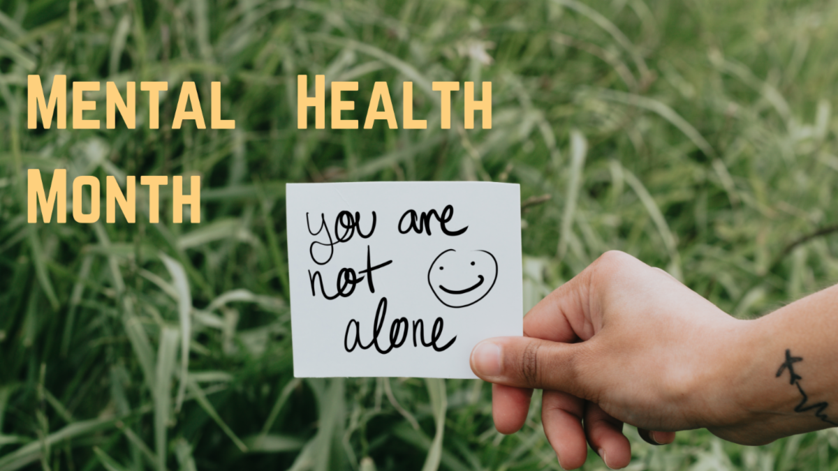 a hand holds a note that reads, "You are not alone.